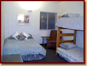 Bedroom with double bed, bunkbed and chair